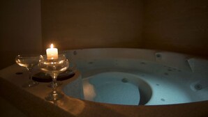 A hot tub with a candle and glasses on a table. - Penzion Pepovka (Bela pod Pradedem)
