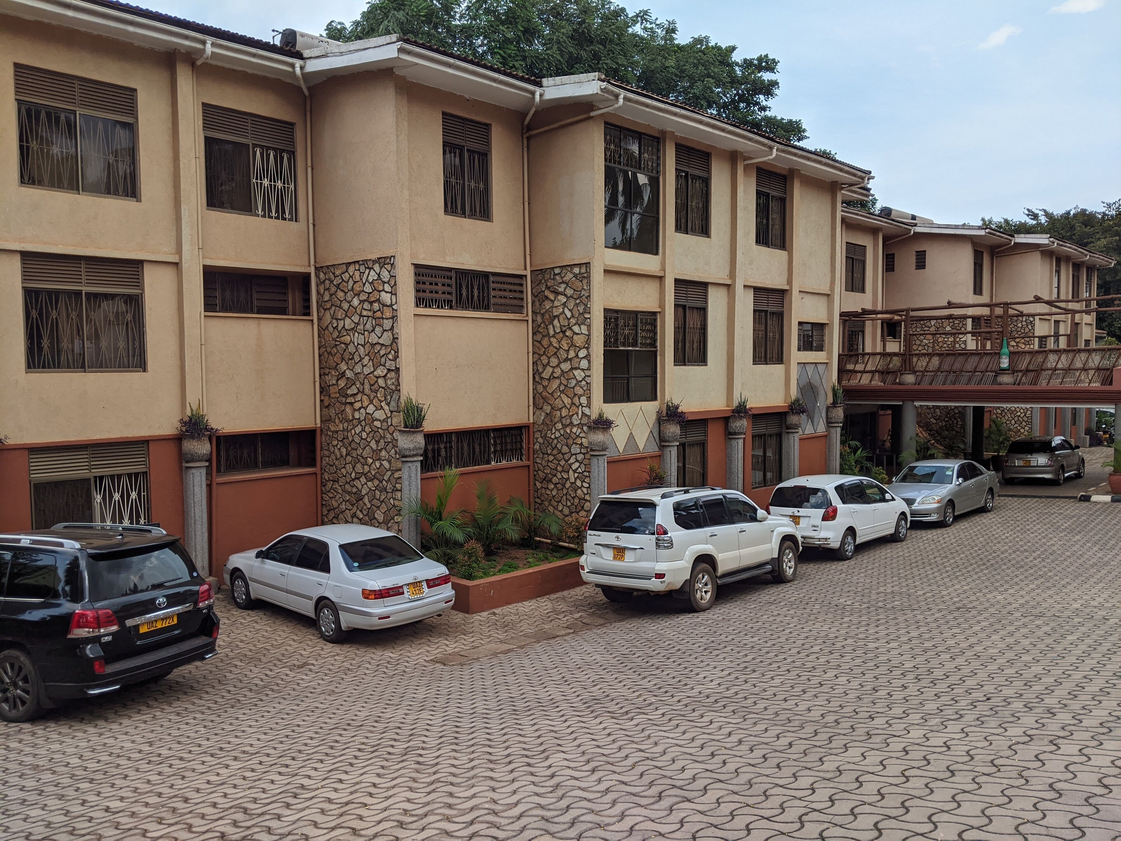 A multi-story building with a parking area.