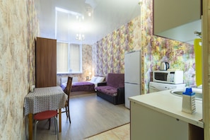 Cozy space with a kitchenette, dining area, and comfortable seating for a relaxing stay.