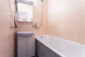 Bathroom features a sink, mirror, shower, and bathtub.