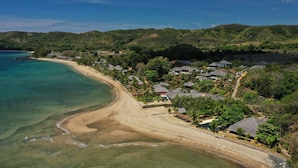 A coastal resort with beachfront villas, clear turquoise waters, and lush greenery. - Home The Residence (Nosy Be)