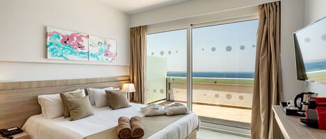 A hotel room with a bed, a desk, a phone, and a painting on the wall.