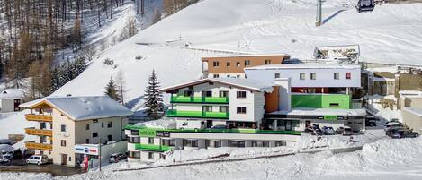 A snow-covered ski resort with a hotel named 'WIESER HOTEL' and 'APART WIESER'.