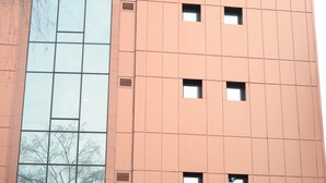 A high-rise building with a large glass facade and a prominent 'R' logo at the top. The building is labeled 'Presidium Palace'.