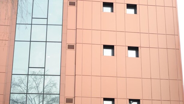 A high-rise building with a large glass facade and a prominent 'R' logo at the top. The building is labeled 'Presidium Palace'. - Hotel Presidium Palace (Lovech)