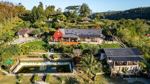 A large estate with multiple buildings, a swimming pool, and lush greenery. - Phu Vara (Chiang Dao)
