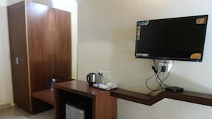 A small kitchenette with a refrigerator, a coffee maker, and a microwave. - Aquays Hotels & Resorts (Port Blair)
