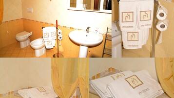 Ein Badezimmer mit Toilette, Bidet, Waschbecken und Handtuchhalter.