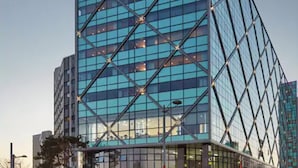 A modern glass building with the "Howard Johnson" sign at the top. - Howard Johnson by Wyndham Incheon Airport (Incheon)