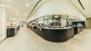 A modern kitchen with a curved counter, stainless steel appliances, and a clean, light-colored floor. - Howard Johnson by Wyndham Incheon Airport (Incheon)