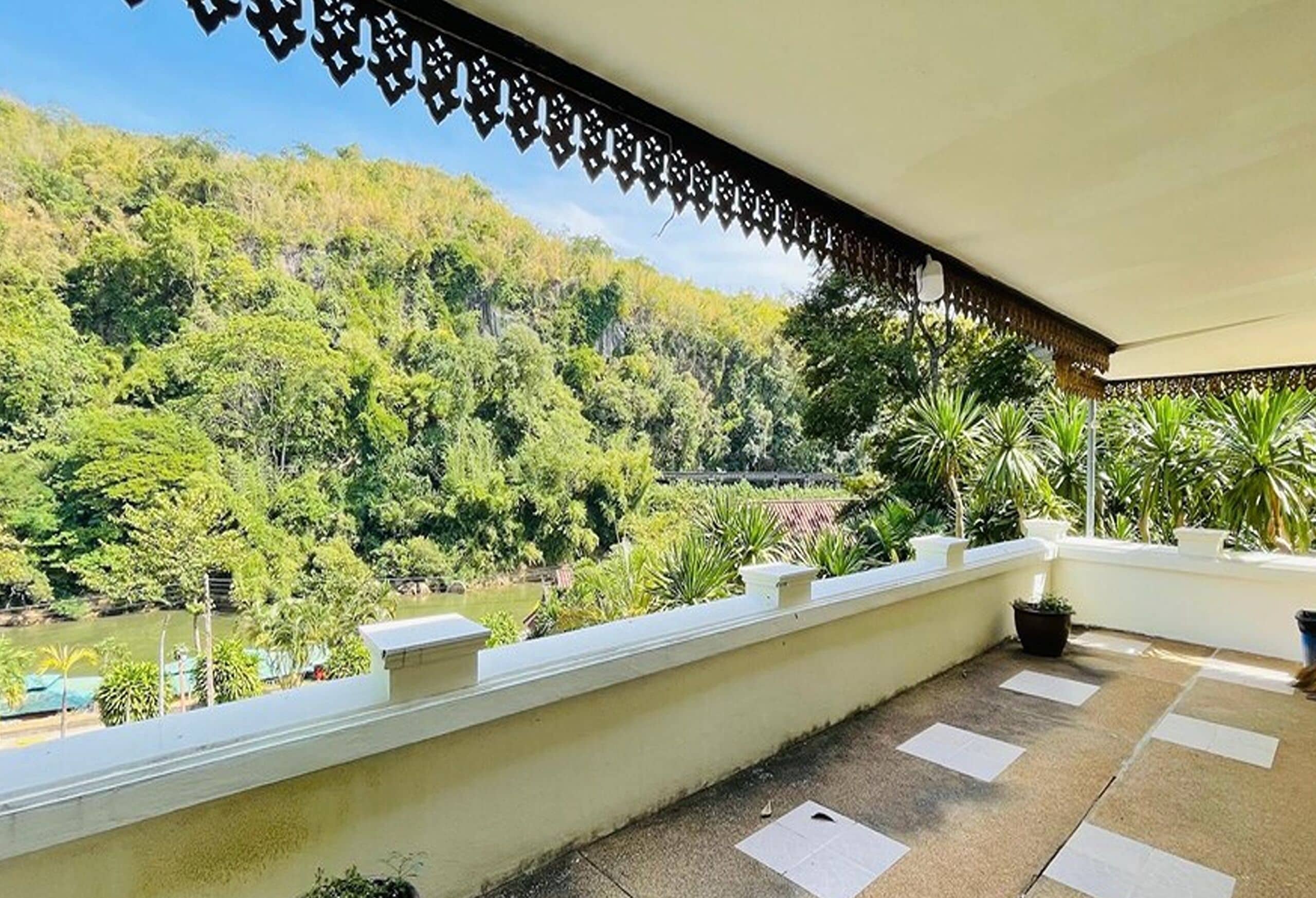 Un balcone con vista su una rigogliosa valle verde e un fiume.