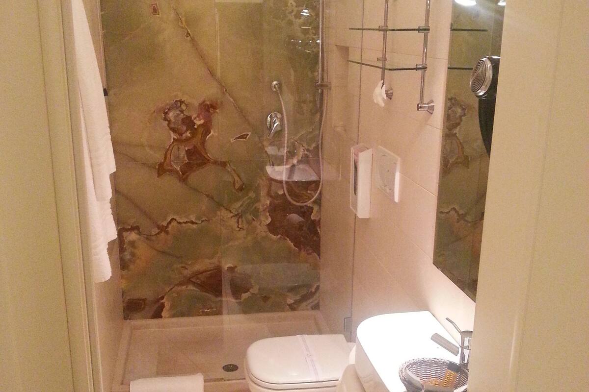 Un baño con ducha, inodoro y lavamanos.