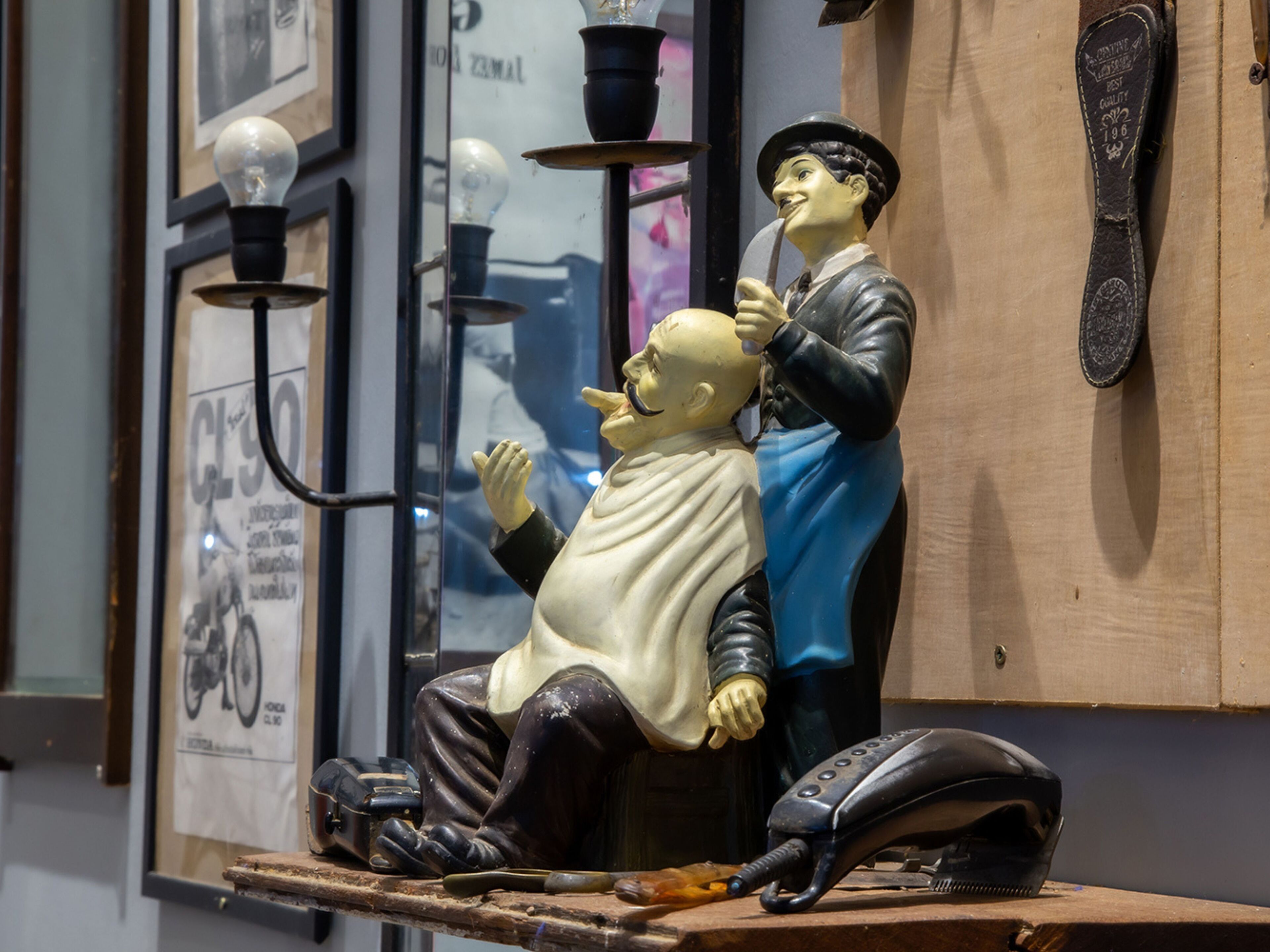 A vintage barber shop with a barber and a customer.