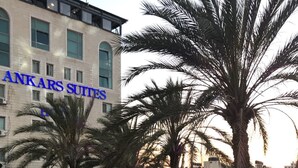 A hotel courtyard with outdoor seating and palm trees. - Ankars Suites & Hotel (Ramallah)