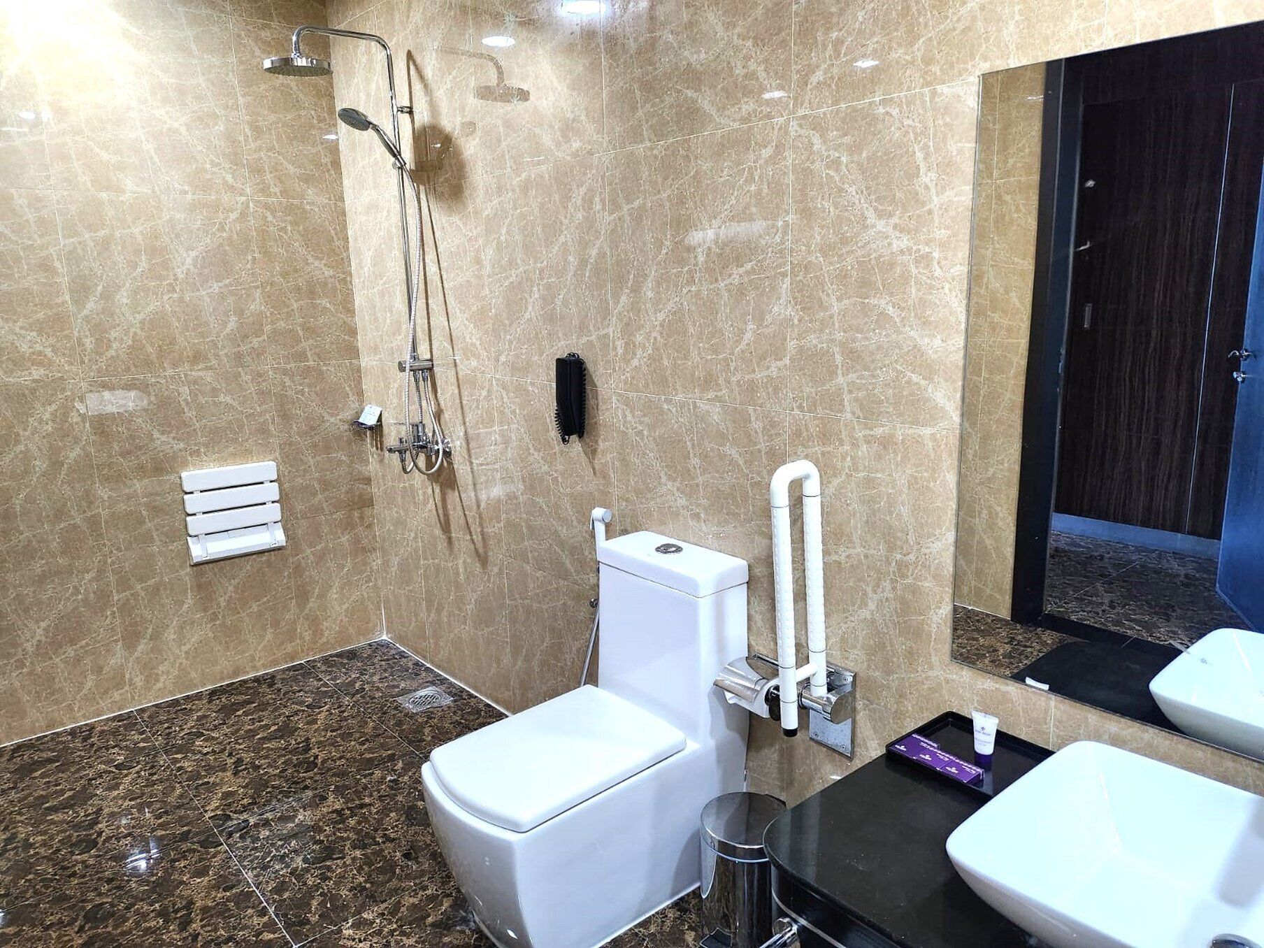 A modern bathroom with a toilet, bidet, and shower.