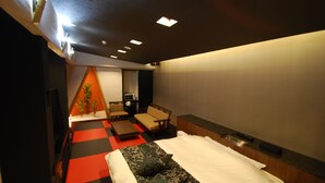 A hotel room with a bed, a desk, a chair, a small table, and a plant. - Hotel Free Style Okayama (Okayama)