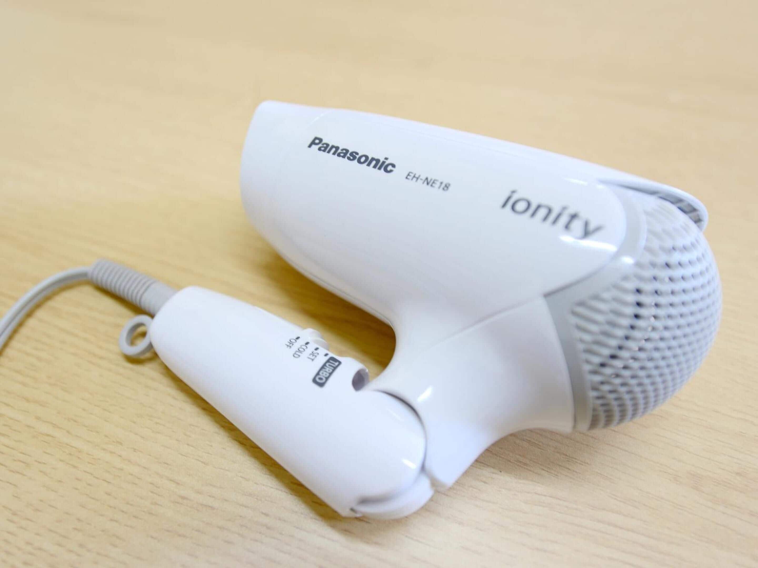 A Panasonic ionity hair dryer on a wooden surface.