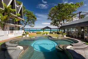 A swimming pool with a circular design and the words "The Bondi Beach" in the center. - The Boathouse Phuket (Karon)