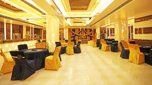 A banquet hall with tables and chairs arranged for a formal event. - OYO 8902 Hotel Ronald Inn (Faridabad)