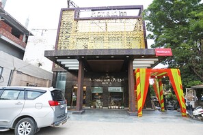 The entrance of a hotel with a sign reading "Ronald Inn (P) Ltd Hotel" and a red banner for "WeddingZ.in". - OYO 8902 Hotel Ronald Inn (Faridabad)