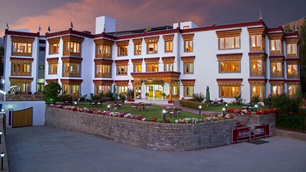 A multi-story hotel with a traditional architectural style, featuring a central entrance and multiple balconies.