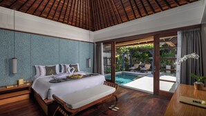A spacious bedroom with a large bed, a wooden ceiling, and a view of an outdoor swimming pool. - The Alantara Sanur (Denpasar)
