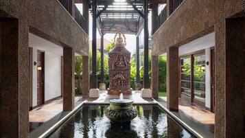 Experience serenity in this tranquil courtyard, surrounded by intricate patterns and a majestic water feature.