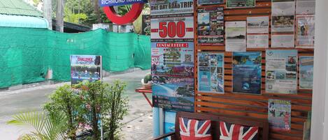 A travel agency with wooden walls displaying various travel posters and a sign for Richmond Travel.