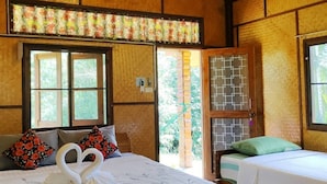 A wooden room with a bed, two windows, a ceiling fan, and a view of greenery outside. - Bansuanphutarn (Ban Ta Khun)