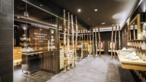 A modern spa with birch tree decor, a sauna, and a reception area. - 24 by AvenidA - Mountain Hotel (Kaprun)
