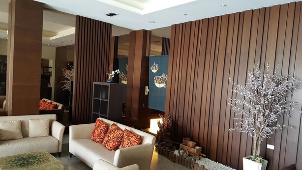 A modern living room with a sofa, decorative pillows, a small table, and a potted plant. - Yang Homestay (Ruisui)