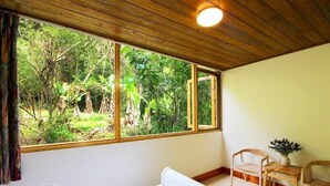 A room with a large window, a bed, and two wooden chairs. - Taomilou (Puli)