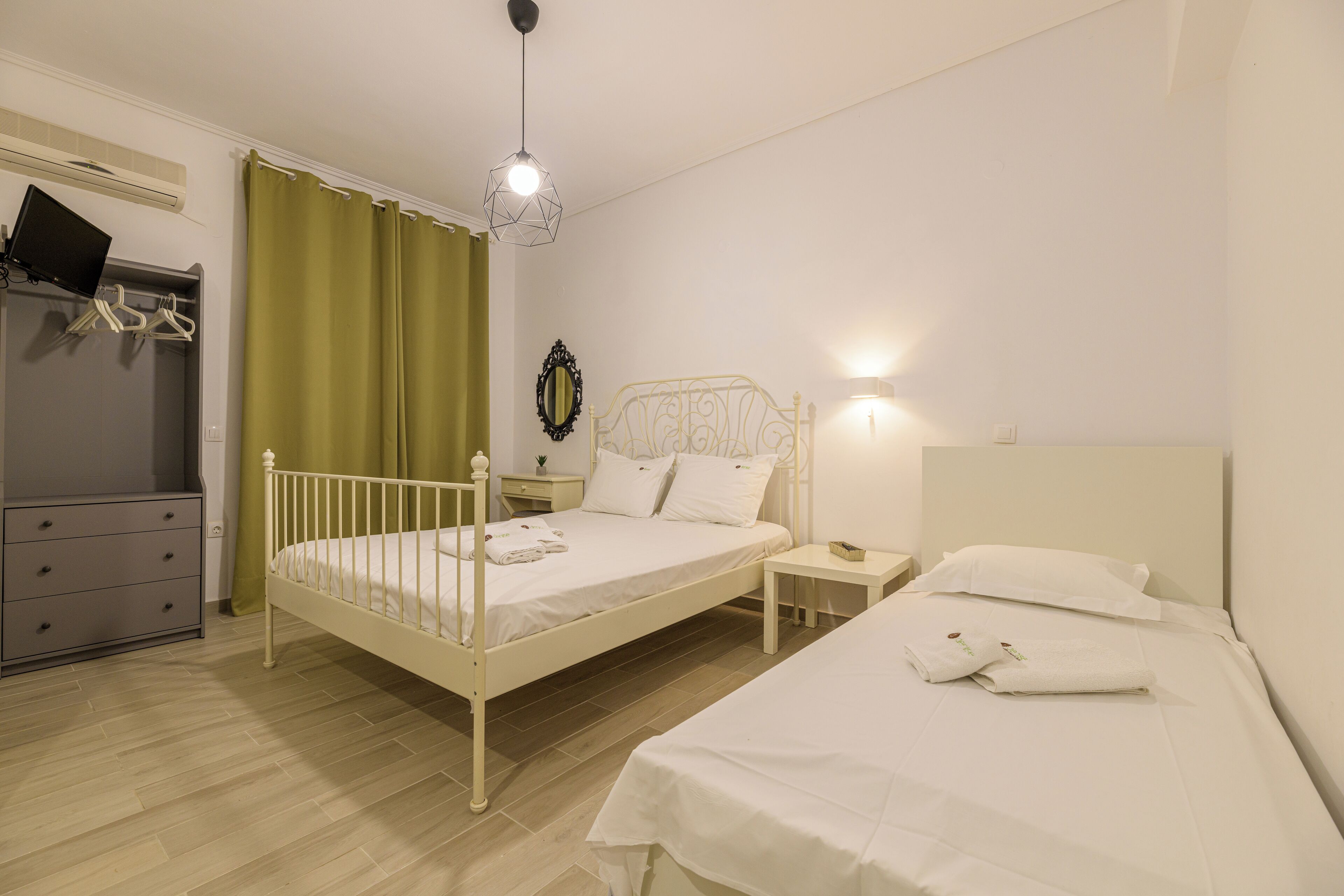 A bedroom with a bed, bedside table, and a dresser.