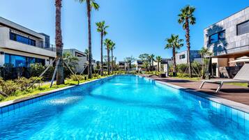 Seasonal outdoor pool, open 10:00 AM to 9:00 PM, pool loungers