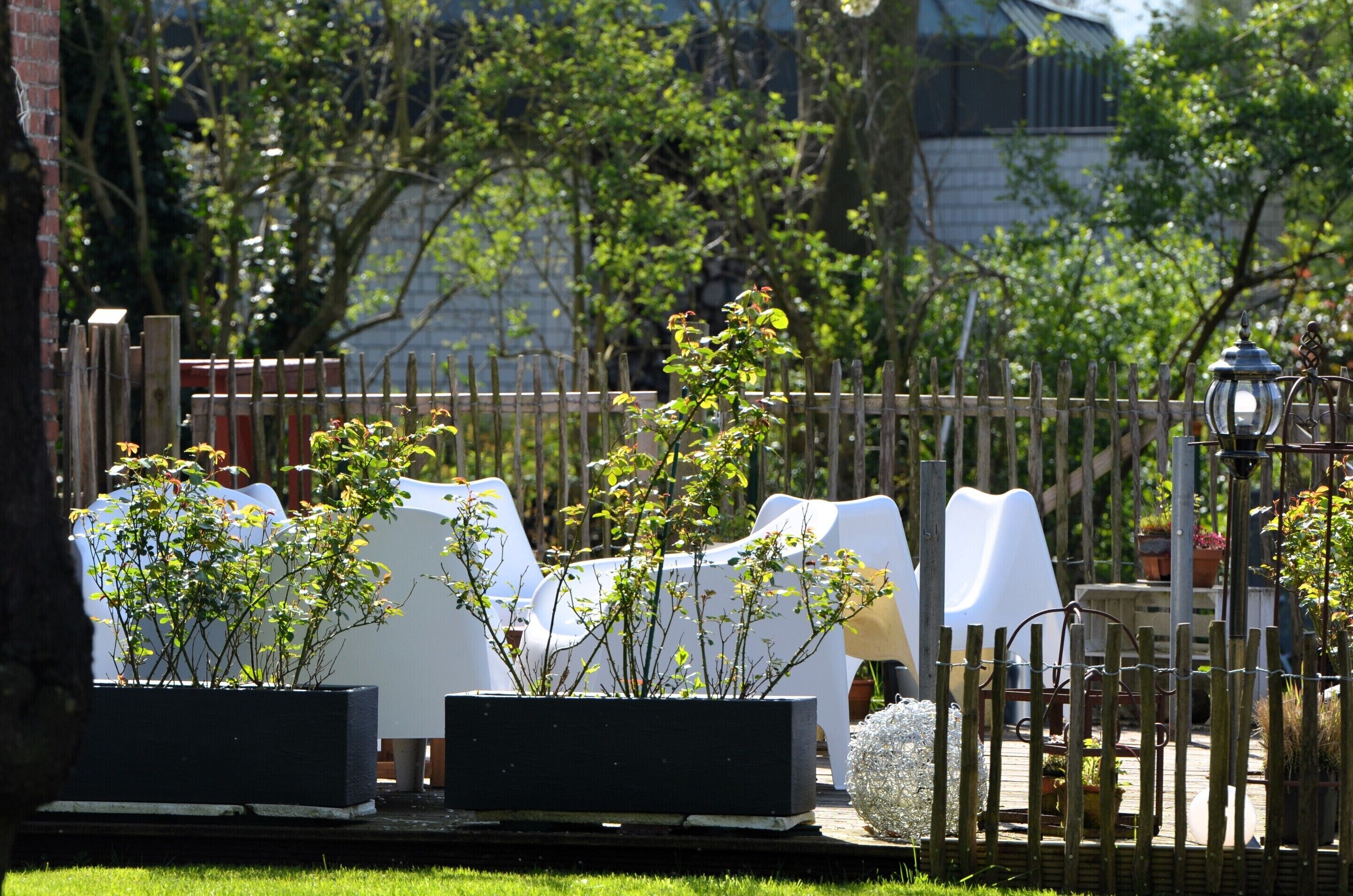 A garden area with outdoor seating and potted plants.