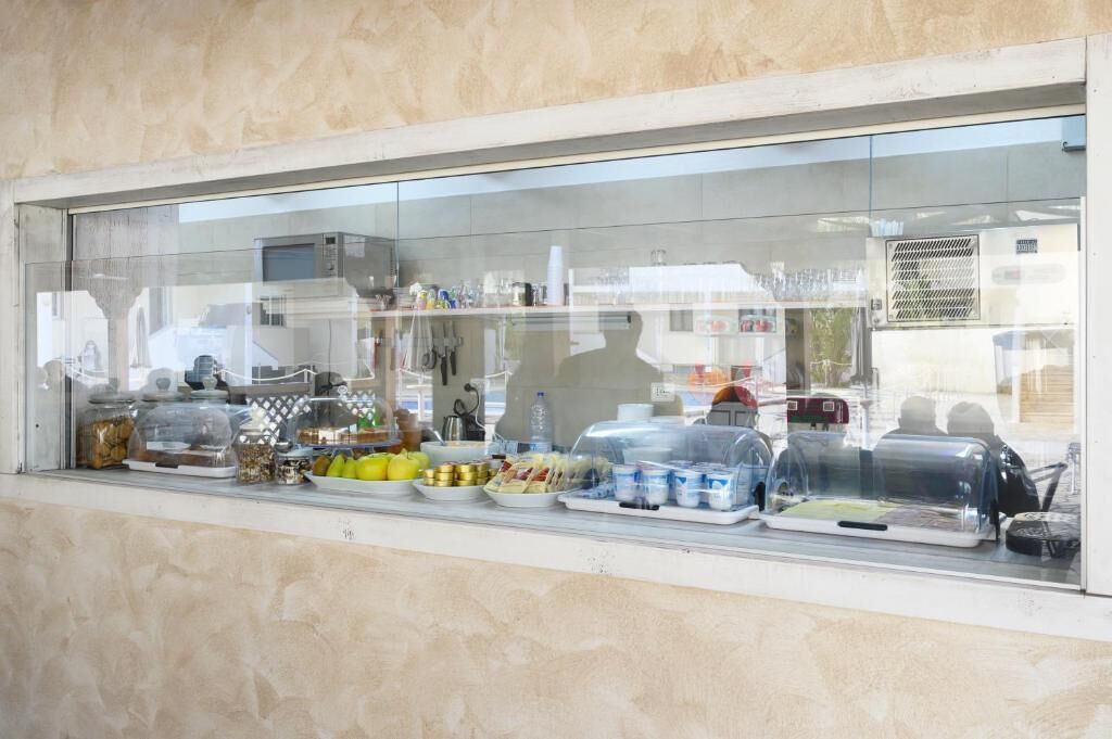 A food display case with various food items and condiments.
