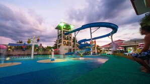 A water park with multiple slides and a pool area. - CML Beach Resort & Water Park (Lemery)