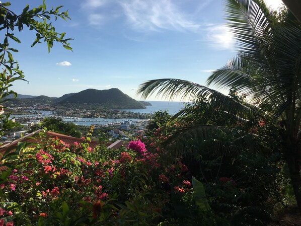 A coastal town with a view of the sea and mountains.