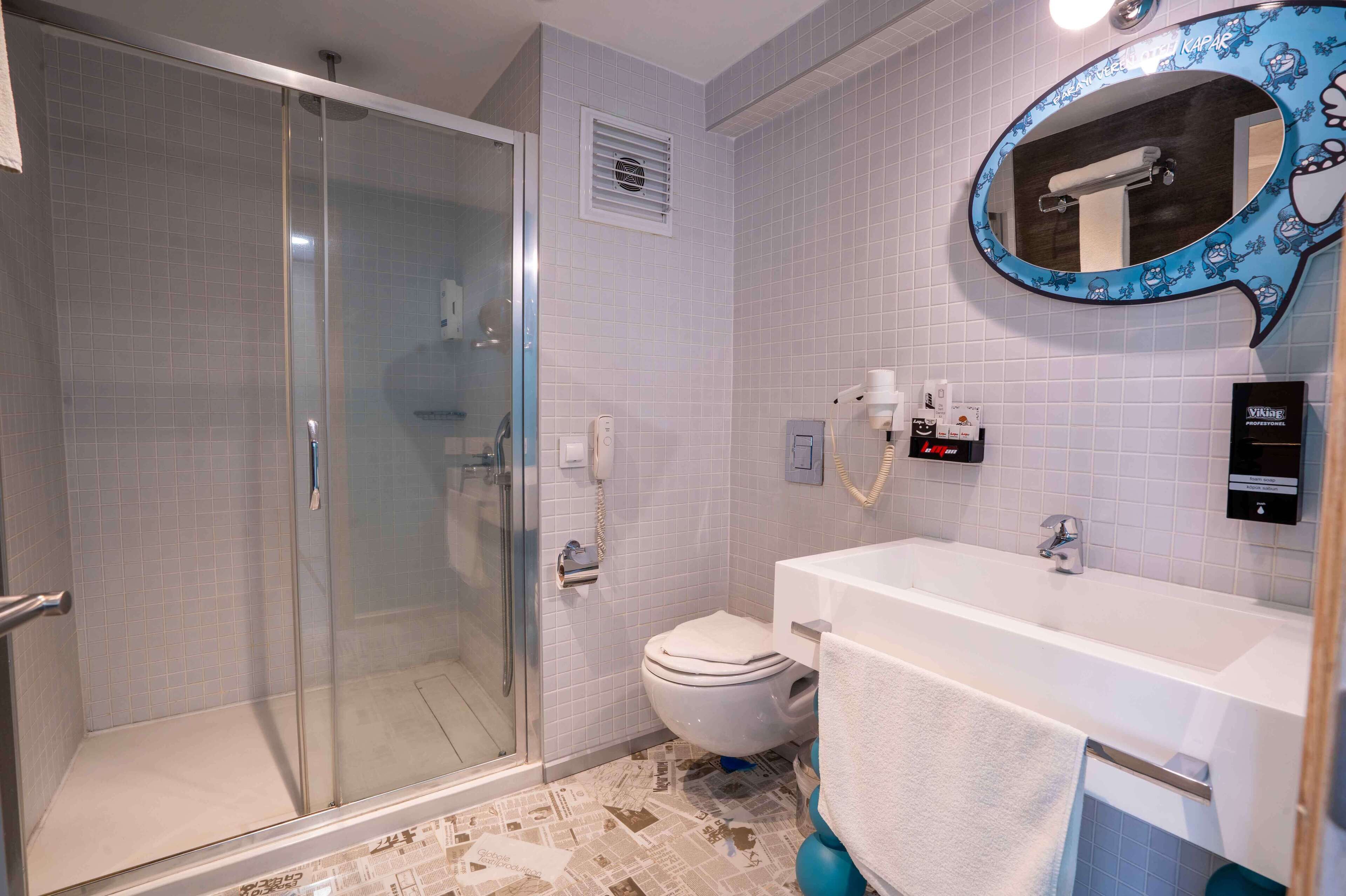 deluxe room | bathroom | shower, free toiletries, hair dryer, bathrobes