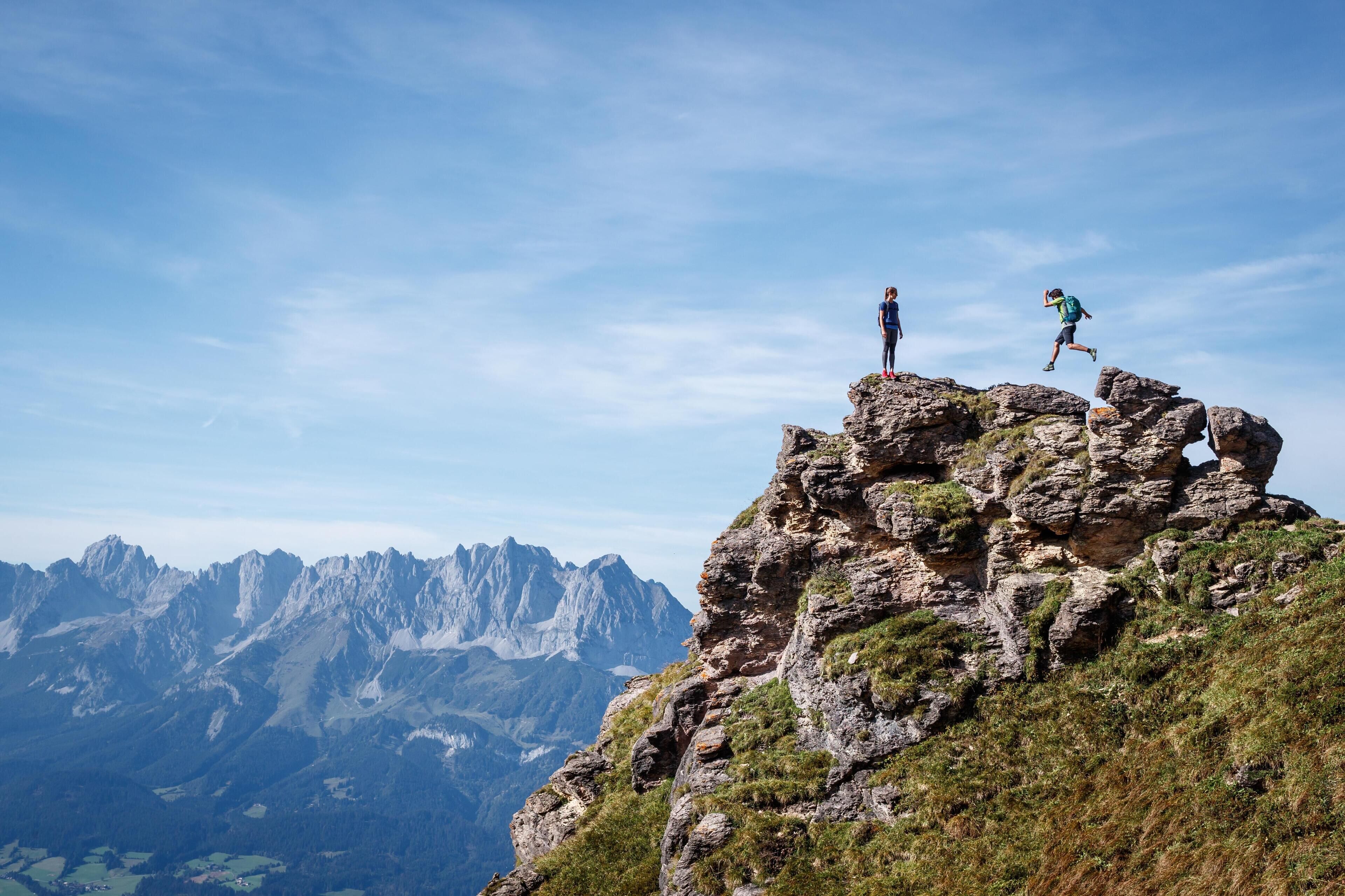 A mountain peak with rocky terrain and a clear sky.