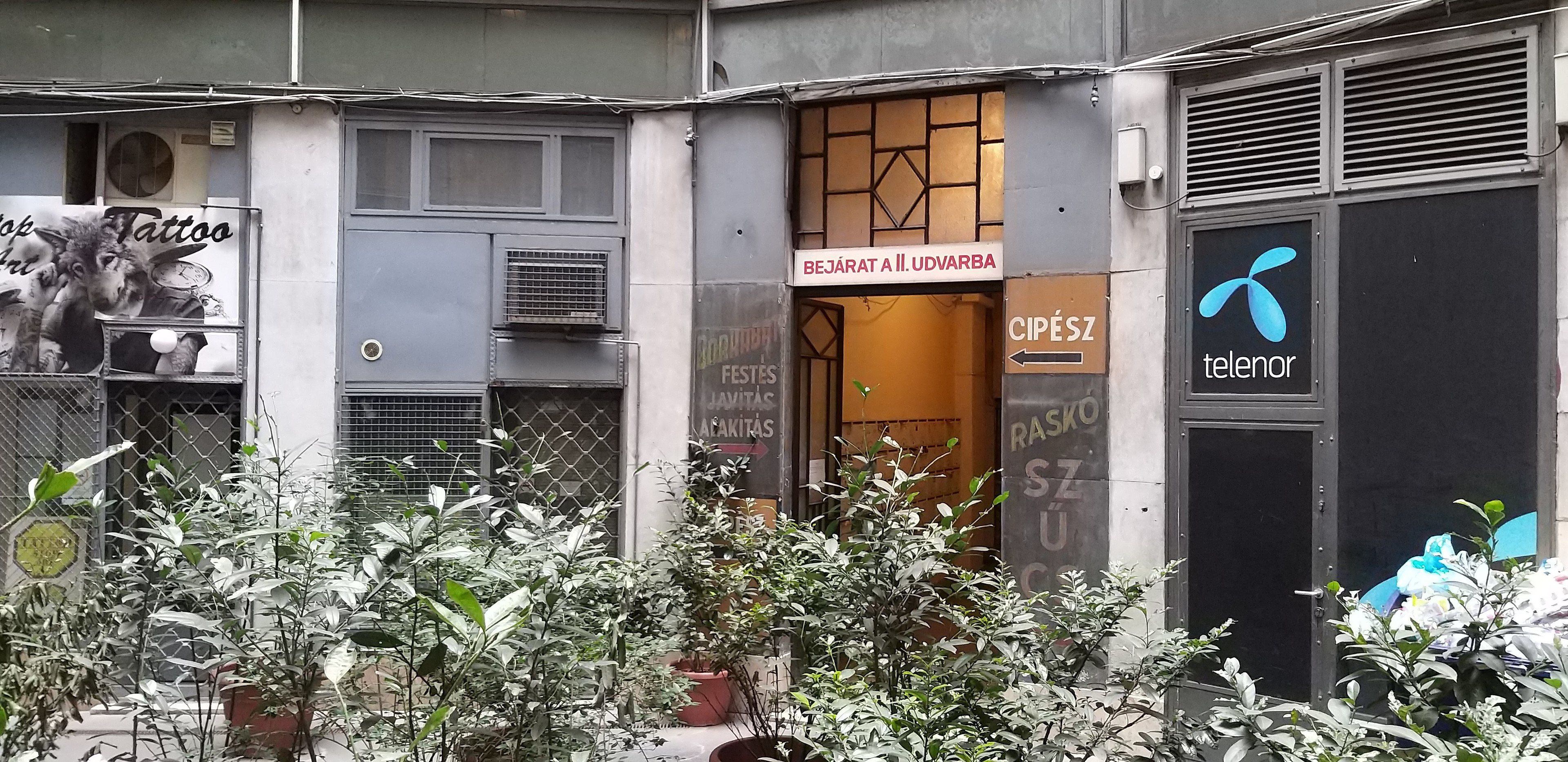 A building with a sign for a tattoo shop and a Telenor store.
