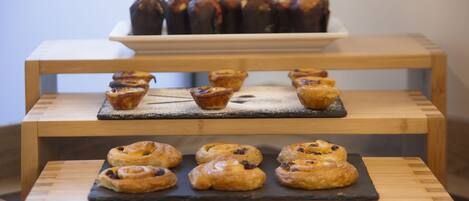 A display of pastries on a wooden stand.