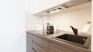A modern kitchen with a built-in stove, a sink, and a coffee machine. - Italianway   - Ciaia (Milan)
