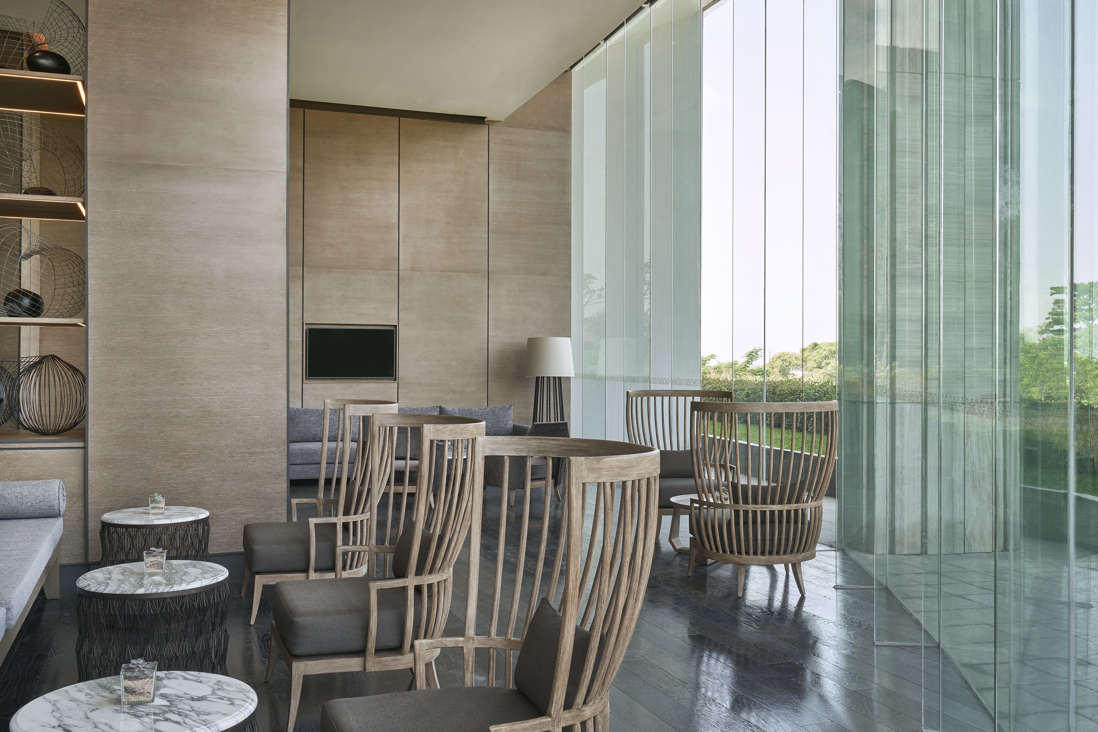 A modern interior with a sofa, chairs, and a TV.