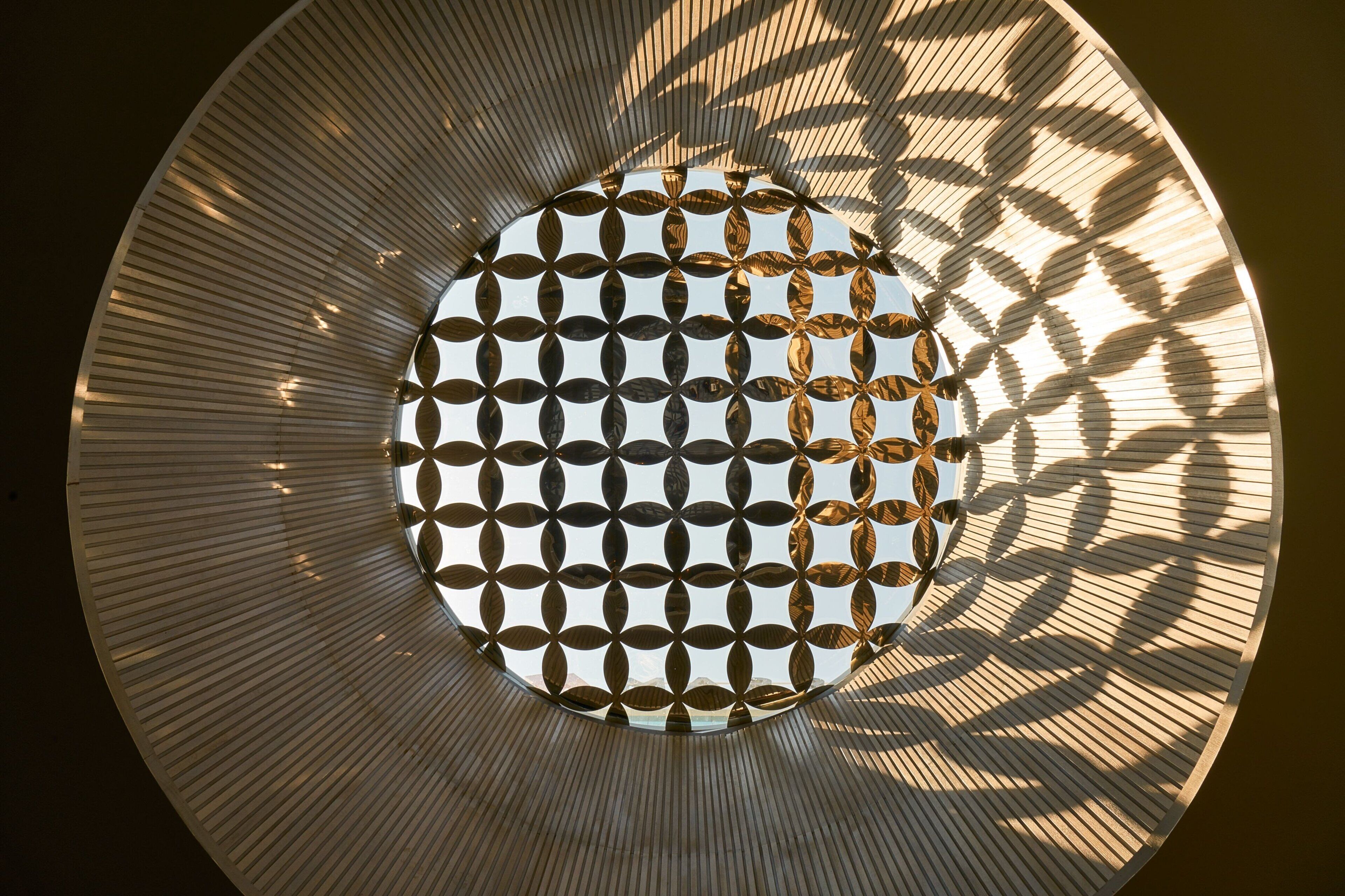 A circular architectural feature with a patterned design and a central opening.