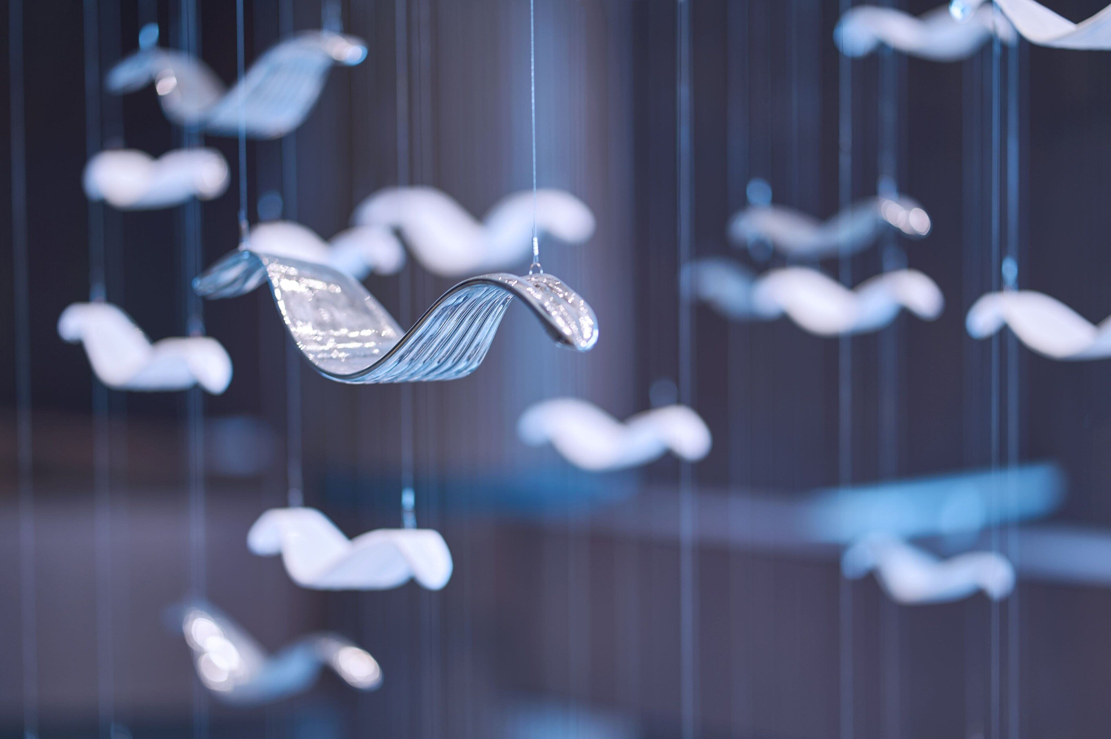 A series of hanging, translucent, leaf-shaped decorations.
