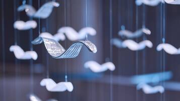 A series of hanging, translucent, leaf-shaped decorations.
