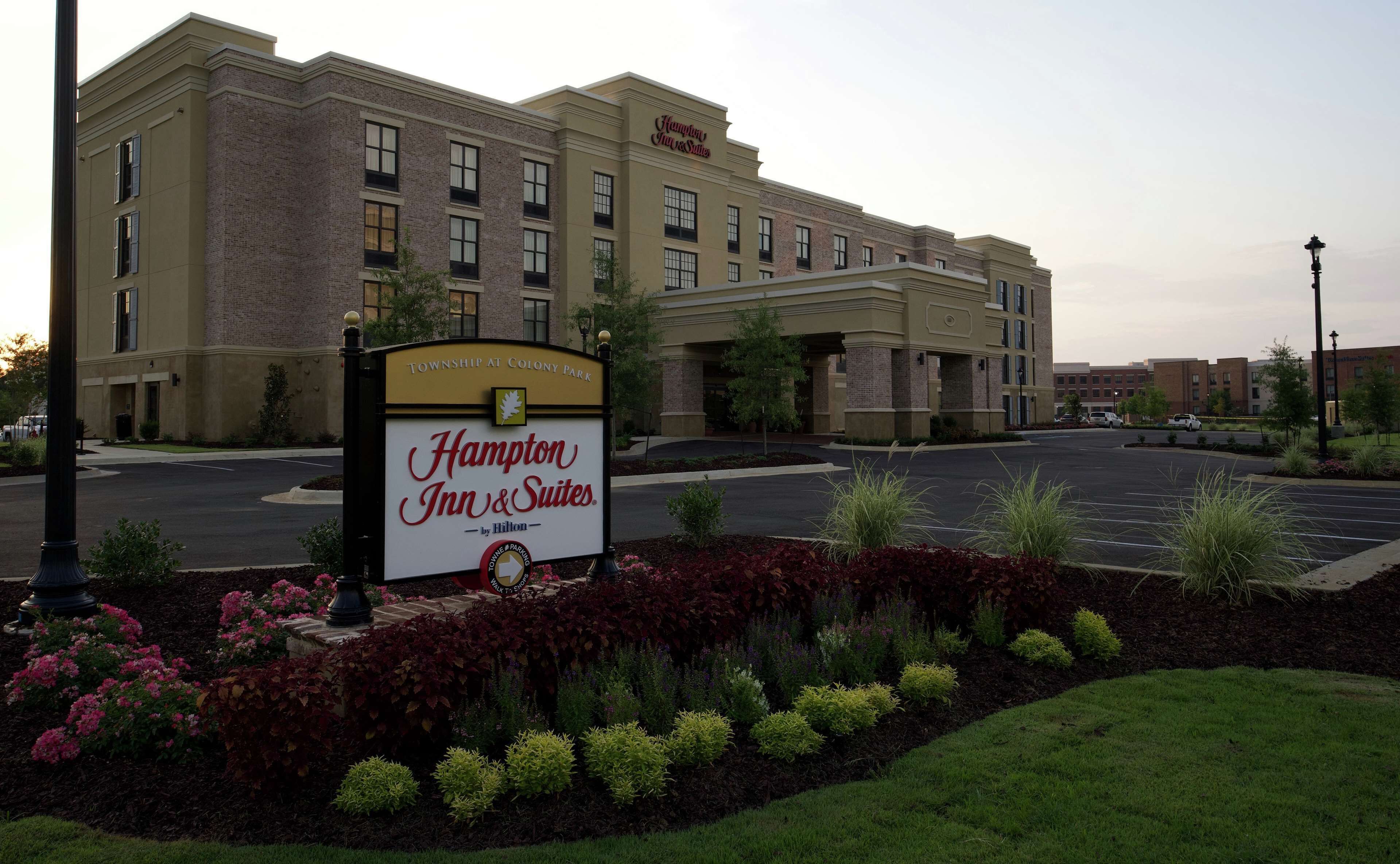 A Hampton Inn & Suites hotel with a sign indicating it is part of the Township at Colony Park.