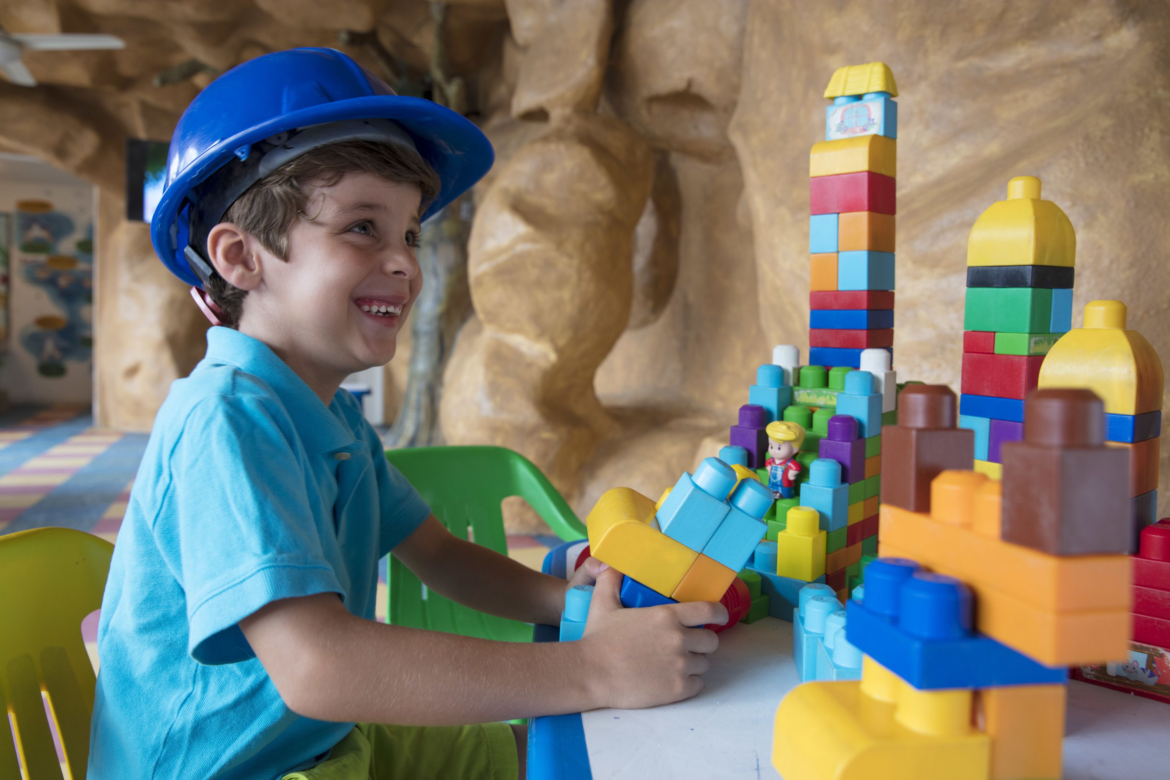 A child playing with colorful building blocks at a table.