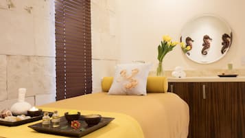 Relax in a stylish room with a large bed, decorative pillow, and elegant vase with fresh flowers.